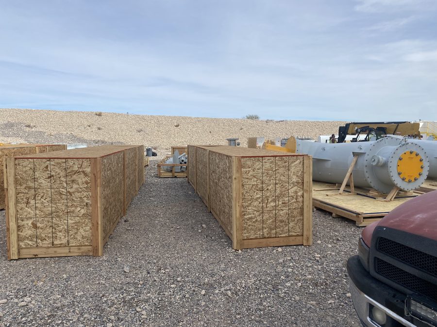 Large equipment crates built on-site in the desert