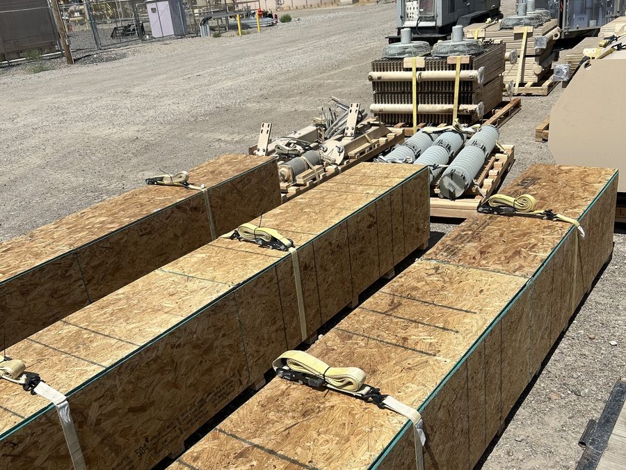 Strapped custom skids staged at a job site